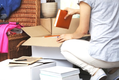 crouching woman packing books