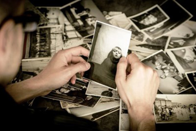 man examining black and white photos
